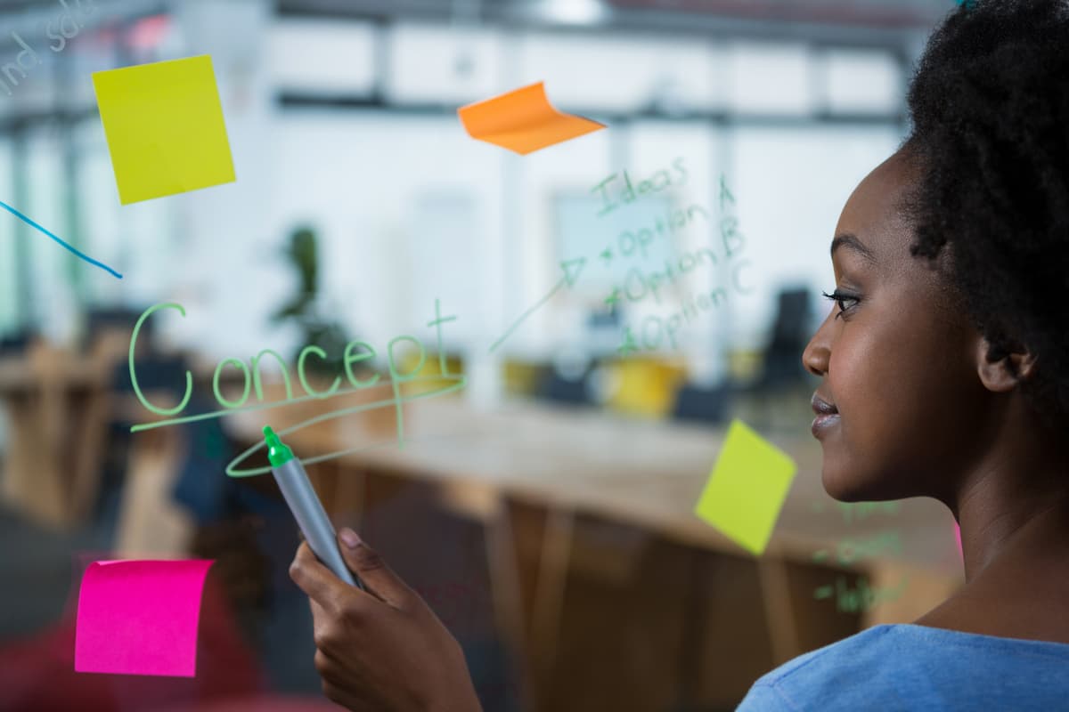 Reeltech Solutions team member writing on a whiteboard